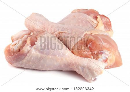 Three raw chicken drumsticks isolated on white background.