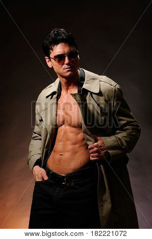 The FBI agent is taking off his coat.