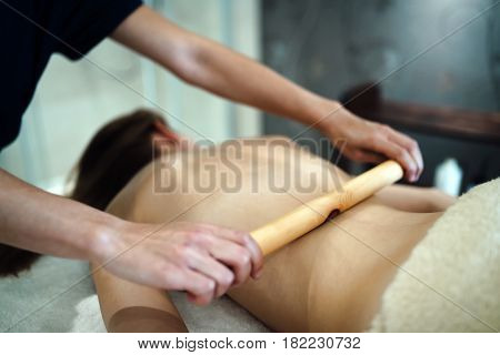 Thai massage therapist treating patient at healthcare salon