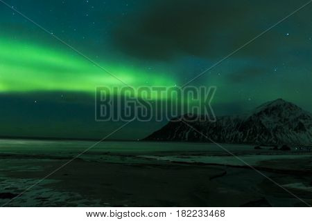 Aurora Borealis Known as Nother Lights Playing with Vivid Colors Over Lofoten Islands in Norway. Horizontal Image Orientation
