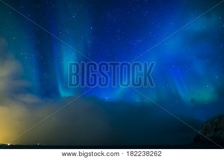 Aurora Borealis Known as Nother Lights Playing with Vivid Colors Over Lofoten Islands in Norway. Horizontal Image Orientation