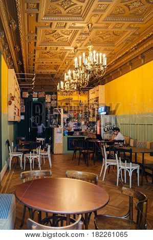 BUCHAREST ROMANIA - APR 1 2016: Interior of a traditional romanina bar with a single male customer drinking a Ciuc beer in central Old Bucharest Bucuresti