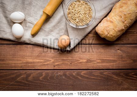 bakery concept with homemade fresh wheat bread on rustic kitchen table background top view moke-up