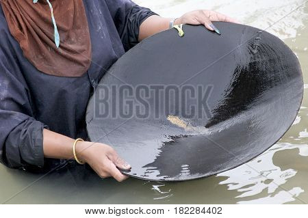 Worker Panning For Natural Placer Gold