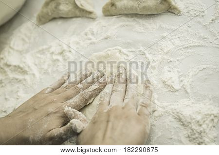 Dough mixing. Baking peremech concept. Flour, dough and meat cooking ingredients. Hands top view of cooking belyash cuisines