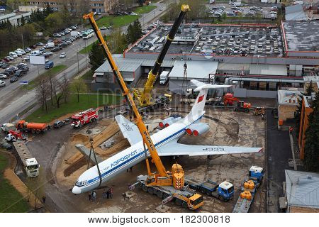 SHEREMETYEVO, MOSCOW REGION, RUSSIA - APRIL 29, 2015: Ilyushin IL-62M RA-86492 putting on a plinth with kranes at Sheremetyevo international airport.