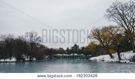 Central Park Boathouse and iced lake in New York City USA