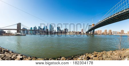 View of Brooklyn Bridge and Manhattan skyline WTC Freedom Tower from Dumbo Brooklyn. Brooklyn Bridge is one of the oldest suspension bridges in the USA