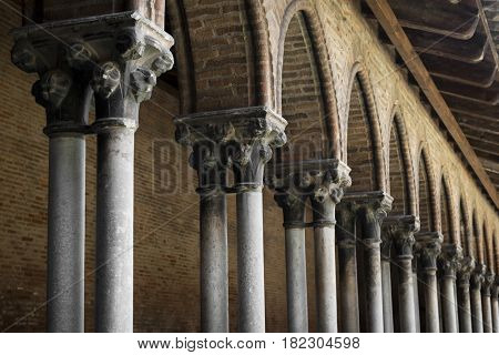 Closeup on columns and arches of cloister in old Dominican monastery Couvent des Jacobins in Toulouse, France. Architectural details.