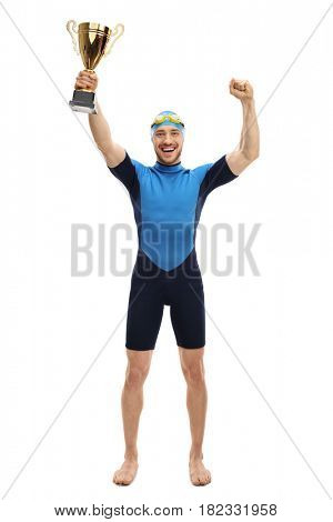 Full length portrait of an overjoyed swimmer holding a gold trophy and gesturing happiness isolated on white background