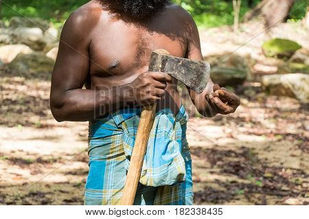 Close up of Vedda man holding axe