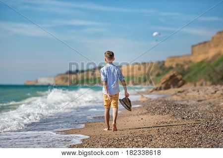 fashion boy on the beach with hat and sun glasses