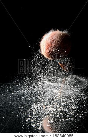 Makeup brusk and powder on black background with copy space