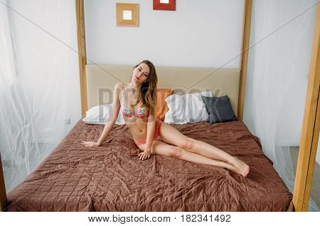 Girl In Flower Panties On The Bed. She Took A Sexy Pose, Showing Off Her Naked Body Beautiful Ass. M