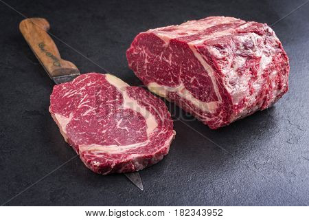 Raw dry aged Kobe Entrecote Steak as close-up on a slate 