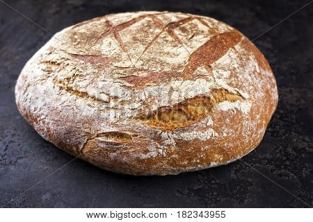 Freshly backed Farmhouse Bread as close-up on an old griddle