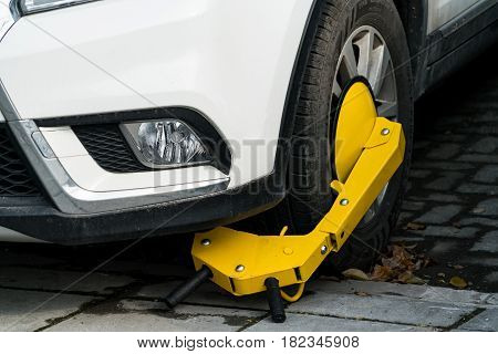 A car parks on forbidden parking lot being wheel clamp lock