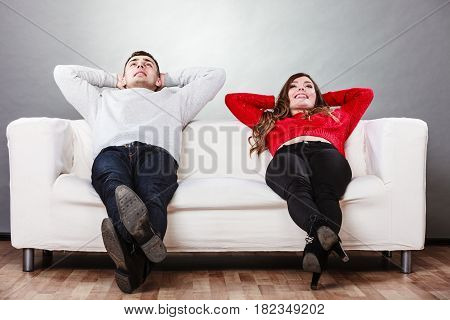 Happy Couple Relaxing Resting On Couch At Home.