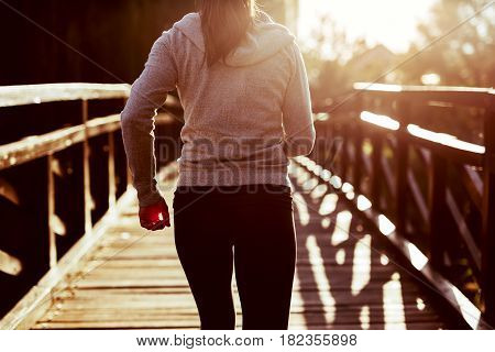 Young female jogger exercising outdoors in nature