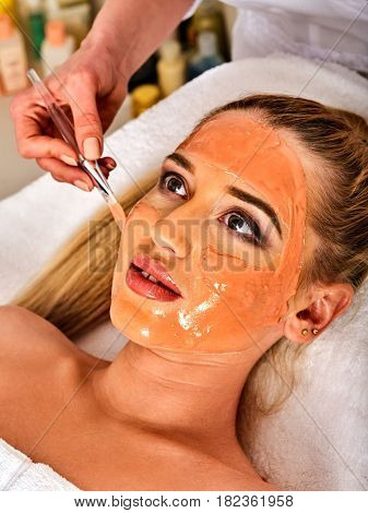 Collagen face mask . Facial skin treatment. Face of woman receiving cosmetic procedure in beauty salon close up number one isolated.