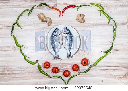 Two grilled seabreams on a plate ready for the barbecue
