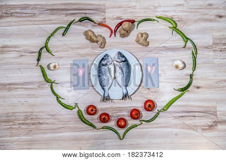 Two grilled seabreams on a plate ready for the barbecue