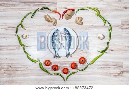 Two grilled seabreams on a plate ready for the barbecue