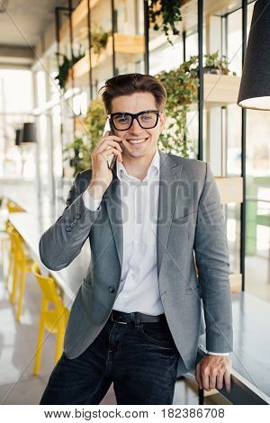 Young Businessmen Working In His Office And Speaking On His Mobile Phone.