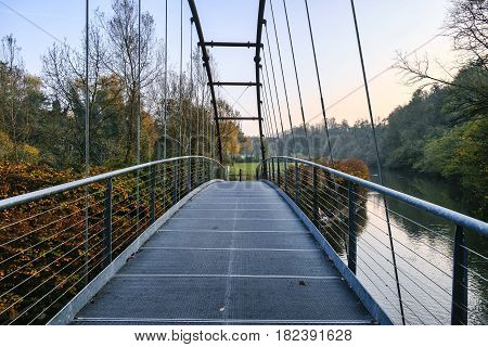 Pedestrian and bicycle track along the Lambro river Monza Brianza Lombardy Italy) at fall. Bridge