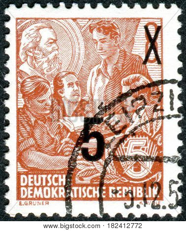 GERMANY - CIRCA 1953: A stamp printed in Germany (GDR) is dedicated to the five-year plan shows a study of Marxism circa 1953