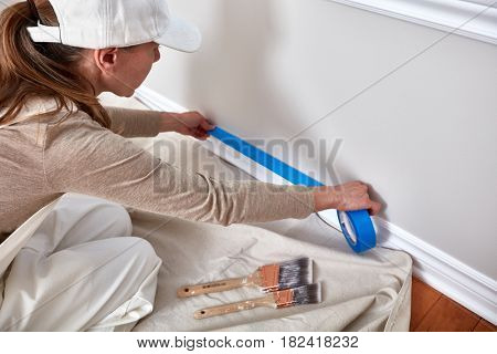 Woman painting wall