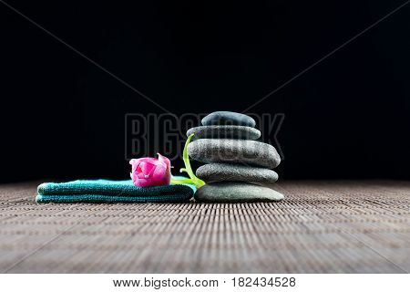 Spa decoration with stones and red flower