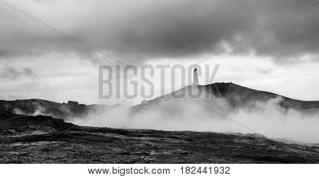 Lighthouse in the Geothermal field of Gunnuhve Iceland. Gunnuhver is a geothermic area in Iceland the ground is boiling hot and there are vents and fumaroles with hot sulfuric steam.