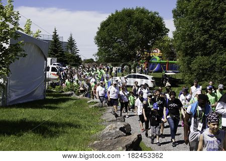 Laval, Quebec - June 14, 2015 - Landscape view of a large group of people starting down a path at the beginning of the 