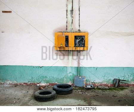 Old broken electric panel in the abandoned building.