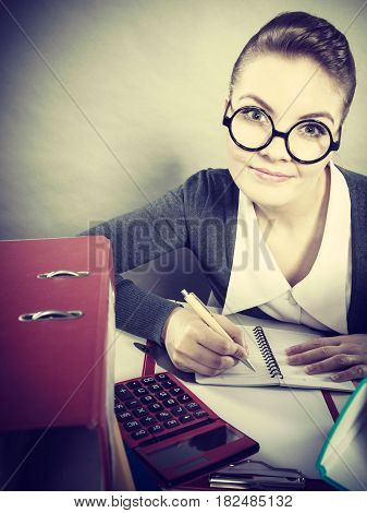 Paperwork administration bureau clerk concept. Young happy secretary at work. Office lady doing her job.