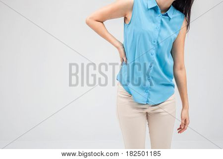 Business woman with back pain holding her aching hip