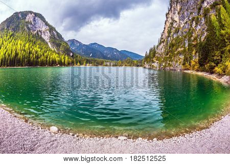 Travel to the Southern Tyrol, Italy. Walk around the Alpine lake Lago di Braies. The concept of hiking. Photo taken fisheye lens