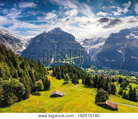 Colorful morning view of Grindelwald village valley from cableway. Wetterhorn mountain located west of Innertkirchen in the Bernese Oberland Alps. Switzerland Europe.