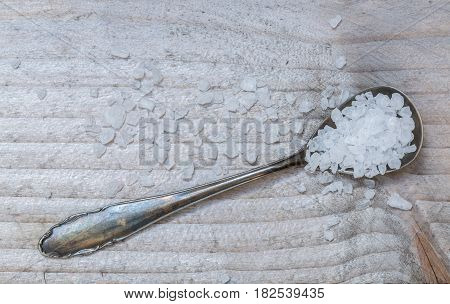 Salt on a spoon macro detail top view