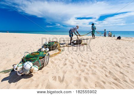 SRI LANKA - Mach 23: Local fishermen pull a fishing net from Indian Ocean on Mach 23, 2017 in Kosgoda, Sri Lanka. Fishing in Sri Lanka is the way they earn their living.