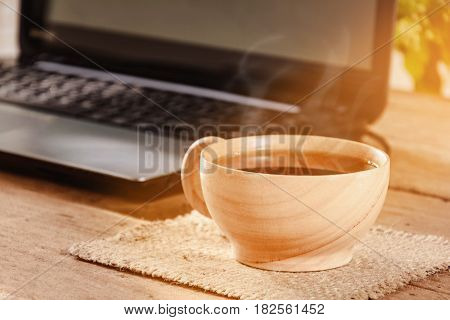 coffee cup and notebook on wood table and good morning