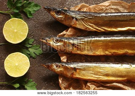 Fish saury smoked paper and the brown concrete background