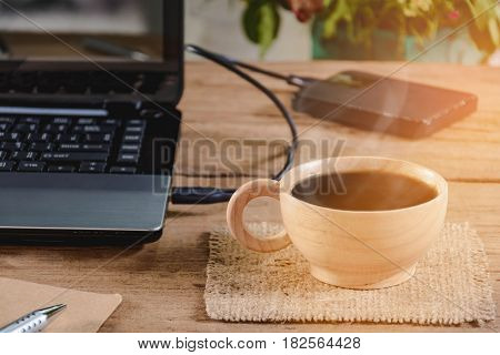 Coffee Cup And Notebook On Wood Table