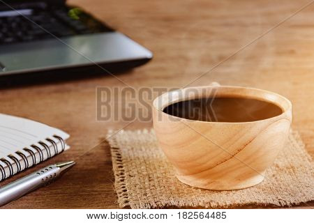 Coffee Cup And Notebook On Wood Table