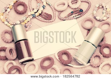 Girlish fashion concept. A lot of glamorous stylish pink woman accessories. Colorful nail polish bottles hair ribbons bracelets necklaces hair clips. Concept for shopping design with copyspace