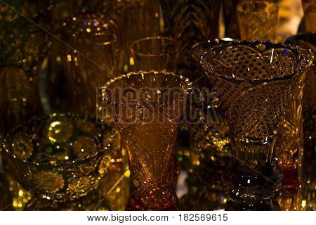 A gold glass vase on a background of blurred vases. Good for a background