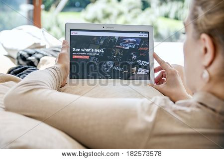 Wroclaw, Poland- April 10Th, 2017:  Woman Launches Netflix Application On Lenovo Tablet. Netflix Is