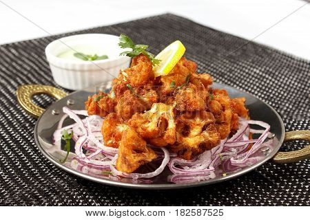 Cauliflower in battered onion with pickled onion isolated on white background