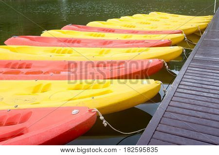 Group of red yellow color Kayak stop at the port